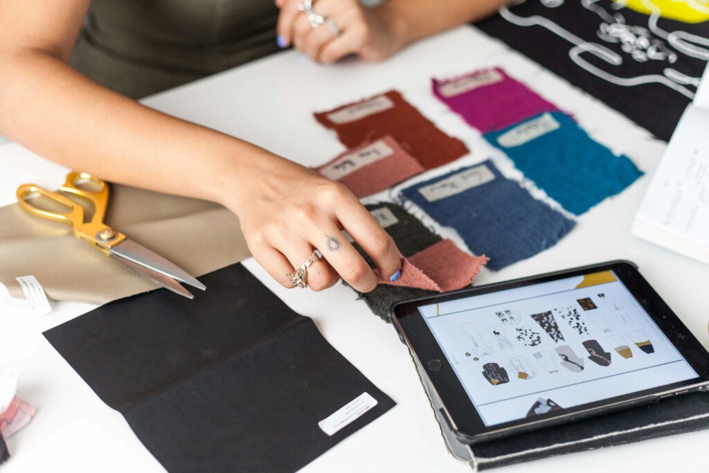 An interior designer working on layout plans and color palettes.