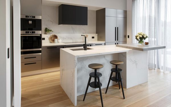Sleek galley kitchen with glossy finish and modern hardware.
