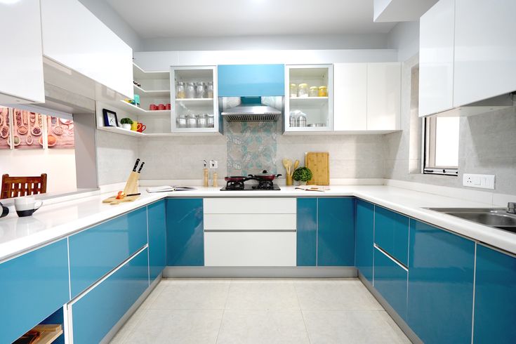 U-shaped modular kitchen in matte finish with wall-mounted chimney.